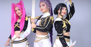 Elenco das Guerreiras Mágicas do K-Pop em apresentação cheia de luzes, figurinos vibrantes e coreografias inspiradas na cultura pop coreana.