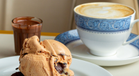 Cappuccino cremoso servido com brownie de chocolate meio amargo e gelato de doce de leite em ambiente aconchegante de cafeteria