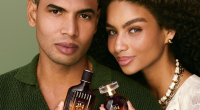 Casal posa segurando fragrâncias Botica 214 Arabian Oasis, lançamento de O Boticário para o Dia dos Namorados, destacando a perfumaria premium inspirada em viagens sensoriais.
